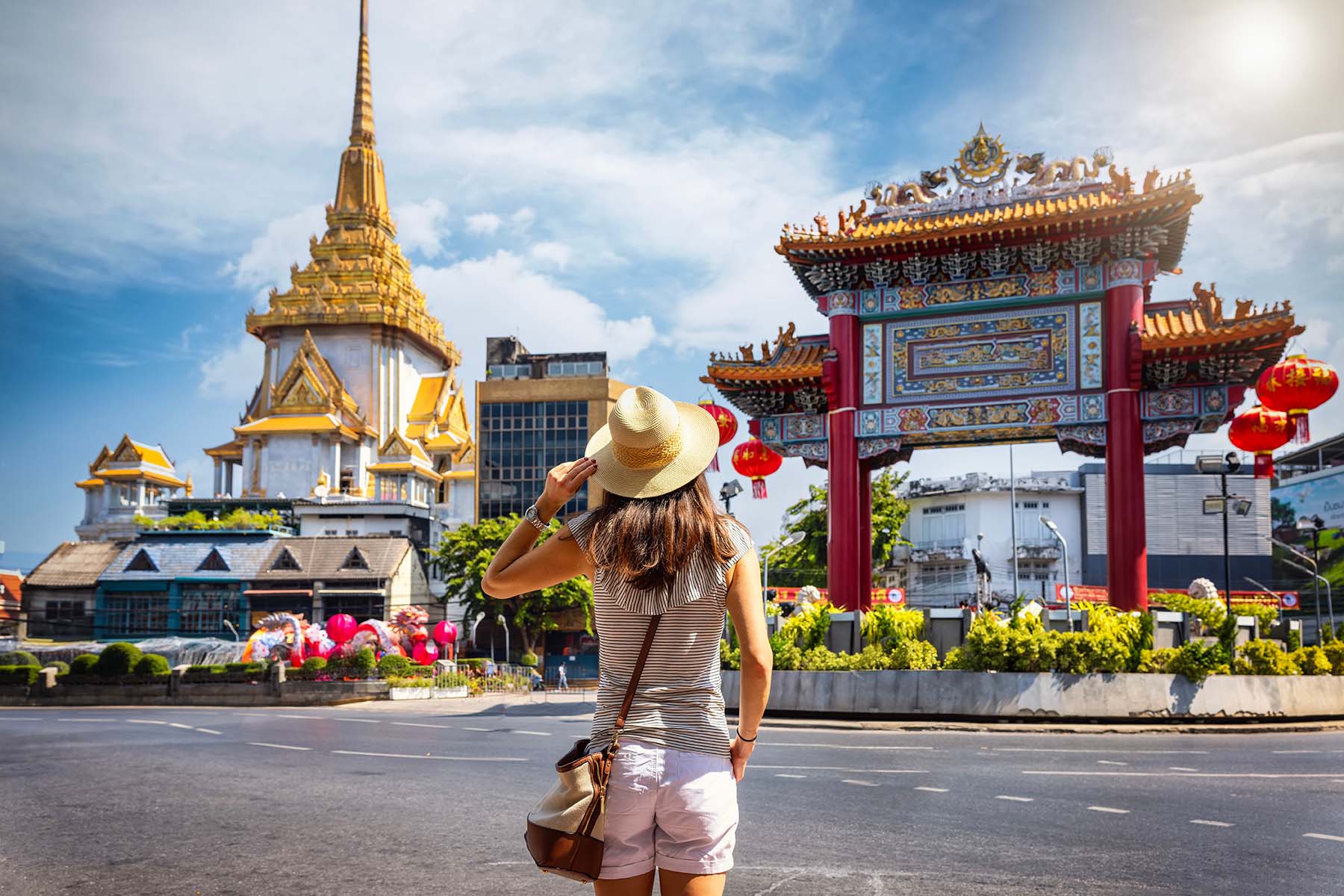 A tourist in front of the Chinatown Gate at the Yaowarat Road in Bangkok. 