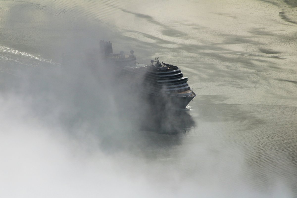 Cruise ship creeps out of the fog on an early morning in Juneau, Alaska.