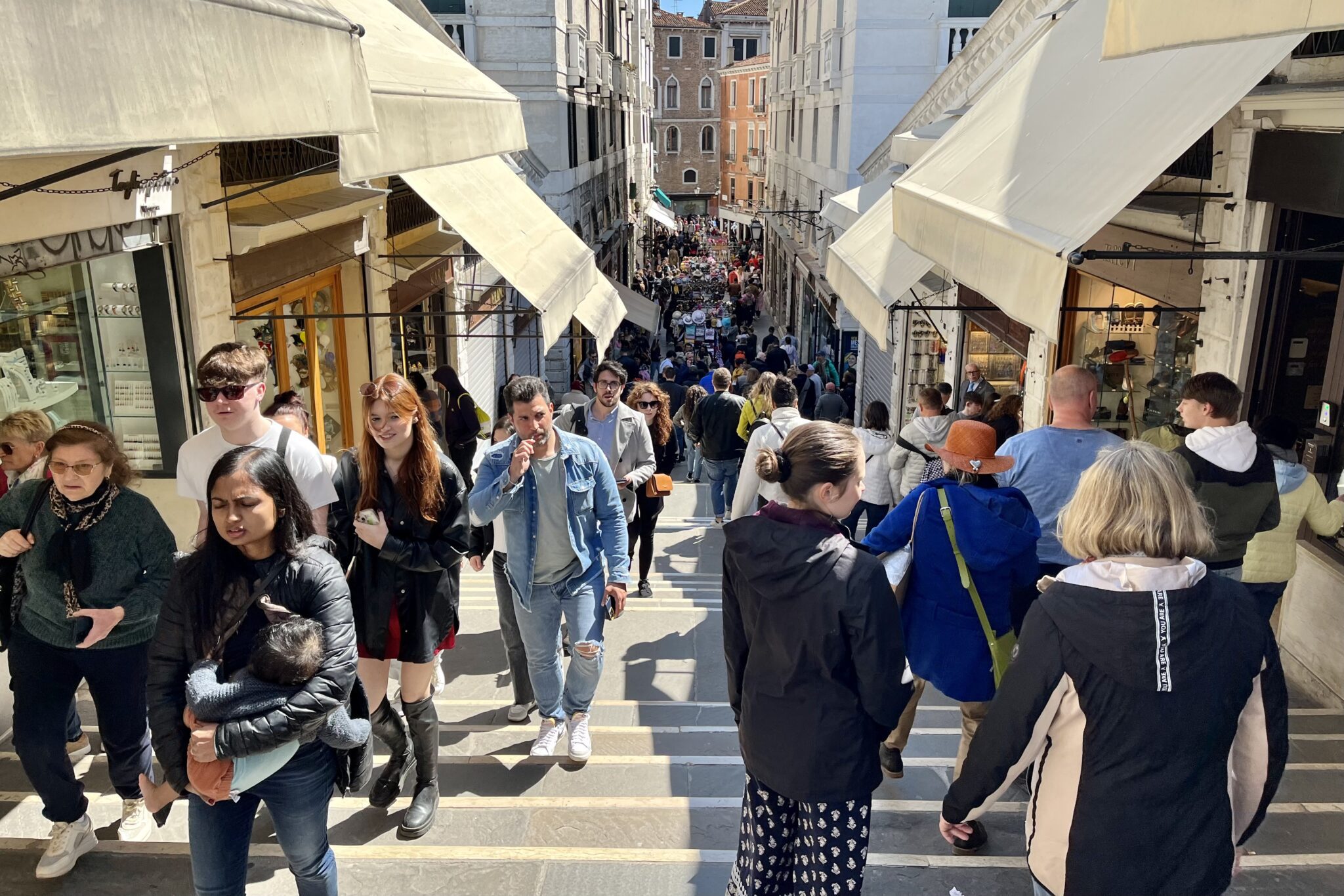 Tourists along the Rialto Bridge in Venice, Italy. 