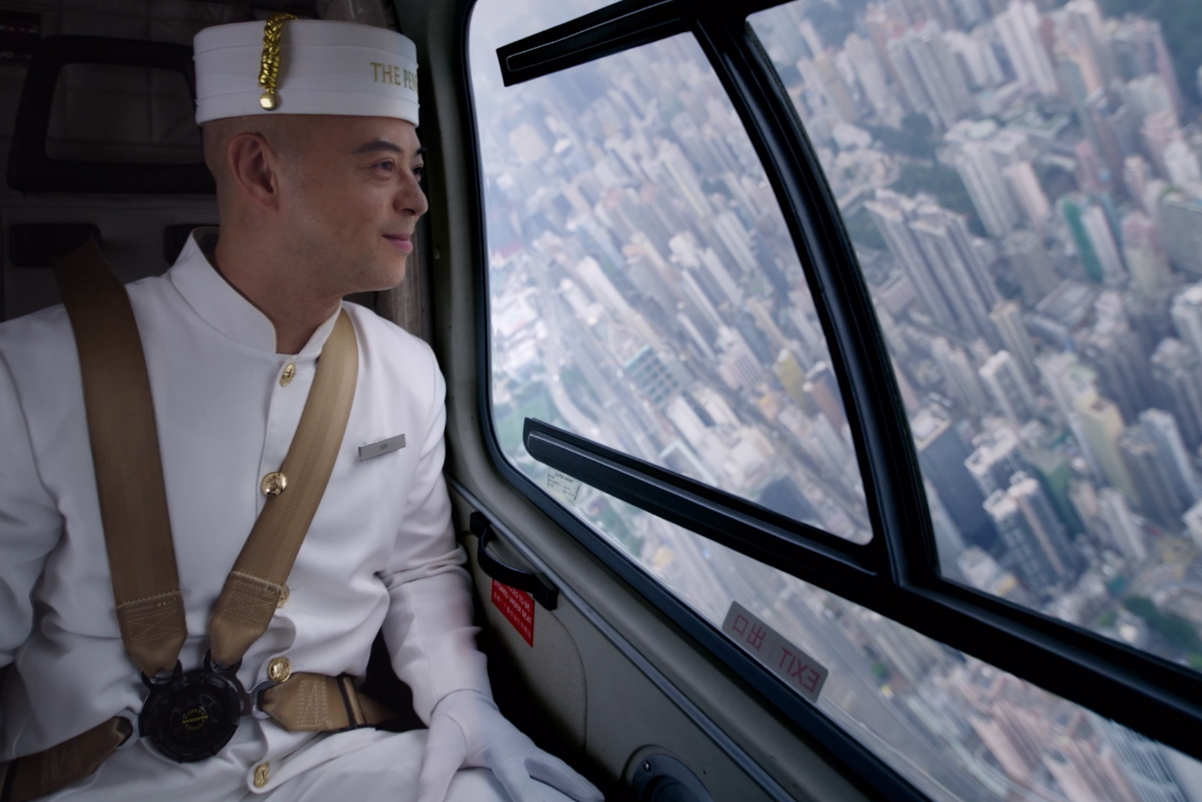 Kam Tsui, a page at The Peninsula Hong Kong, takes a helicopter ride in a new commercial.