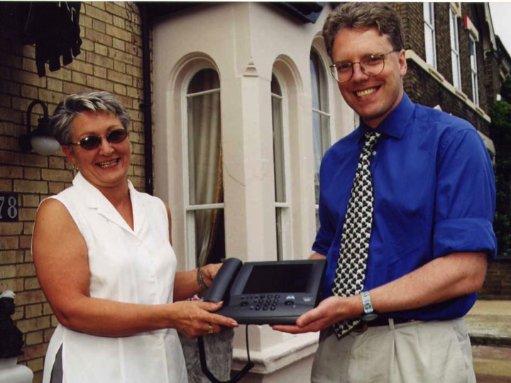 Stella Dunton, the proprietor of the Charlotte House Hotel, Peterborough, UK, and then-Active Hotels COO Matt Witt, hold an Alcatel Web phone around 2000 that was used to connect hoteliers to the Internet. This property was one of the first to go online with Active Hotels.