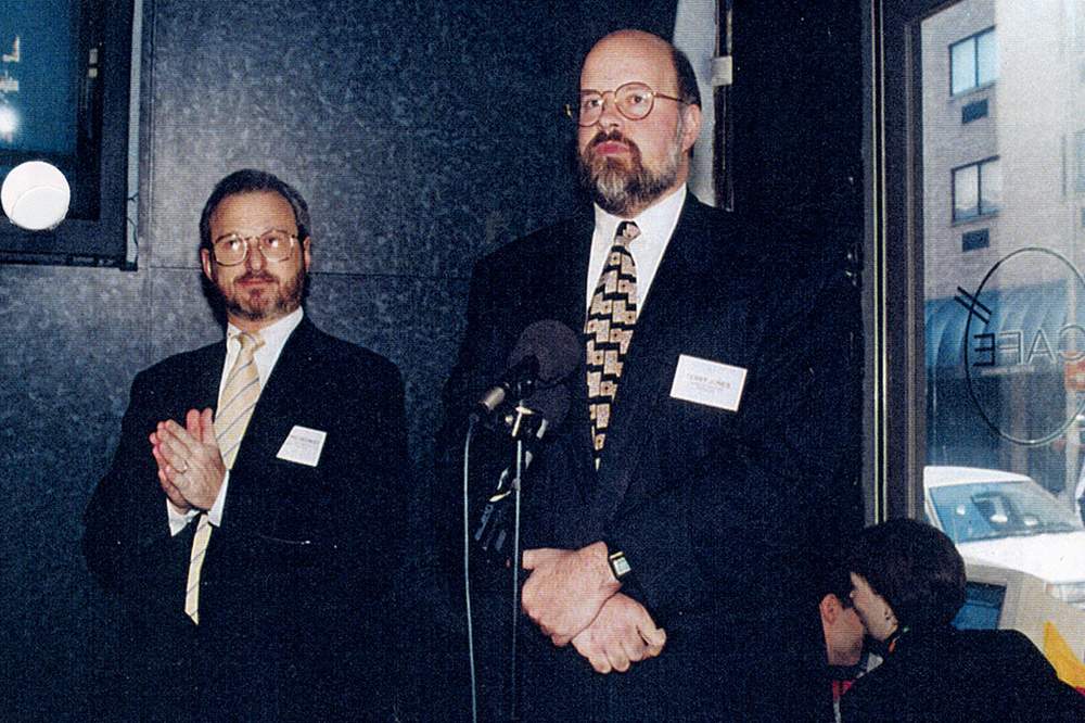 Terry Jones, right, speaking at the Travelocity launch party in New York City alongside Worldview president Neal Checkoway